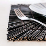 Black seagrass placemat with radial woven pattern