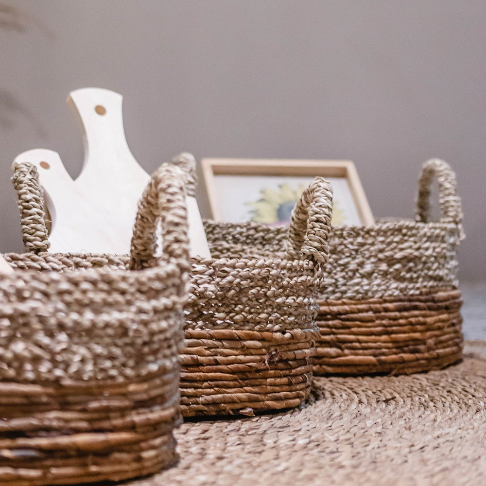 Beige and brown woven seagrass and banana fibre storage basket