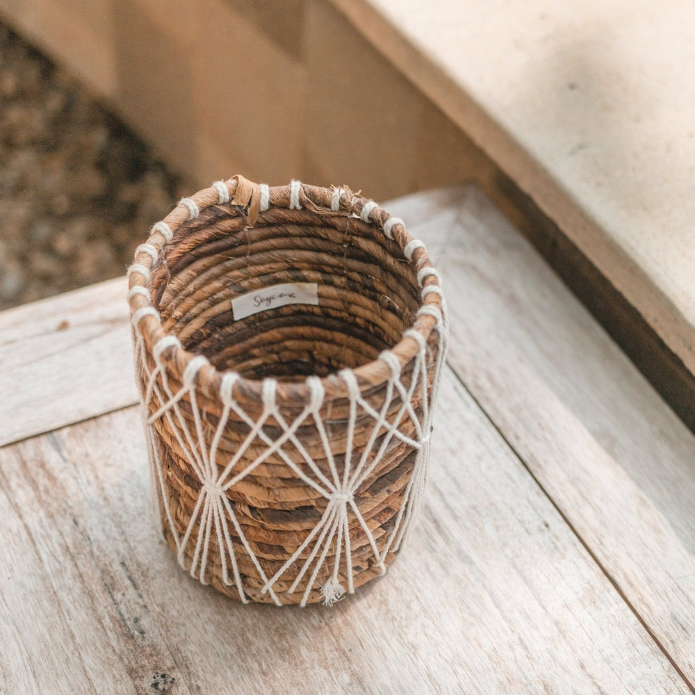 Brown and white woven banana fibre storage basket with cotton macramé lacing