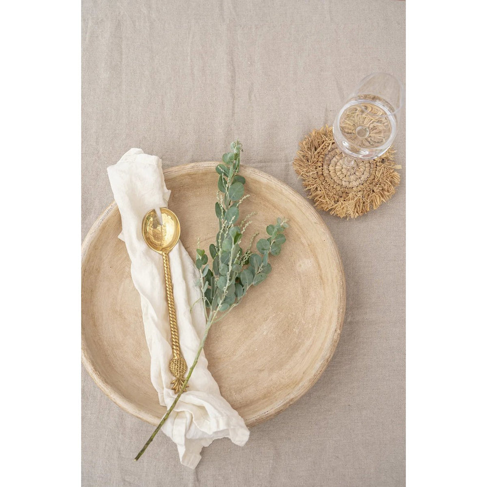 Natural raffia coaster with fringed edge