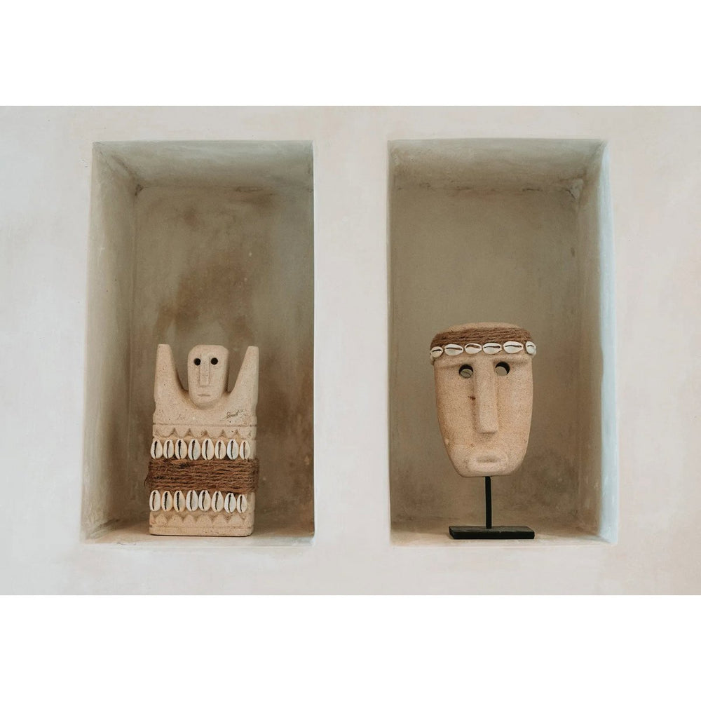 Sandstone statue with cowrie shells and jute wrap