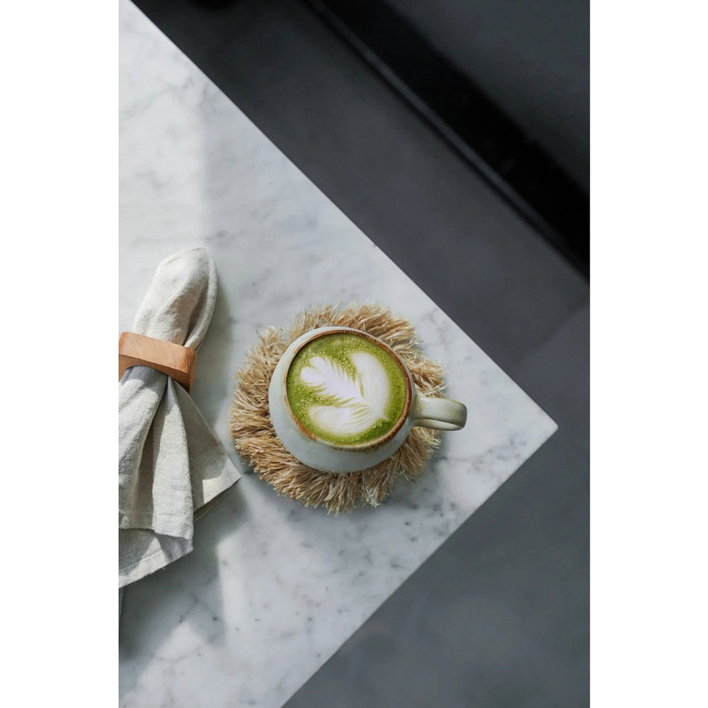 Natural raffia coaster with fringed edge
